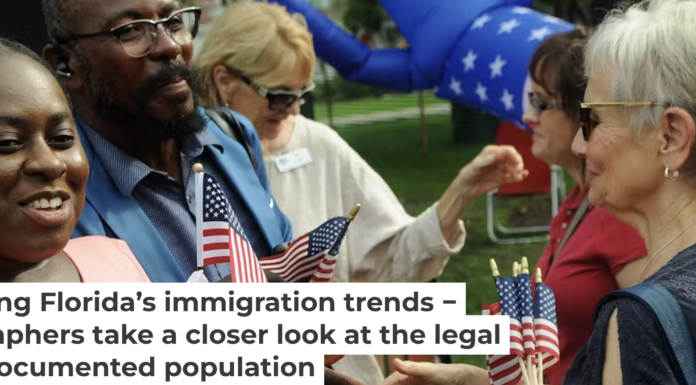 New U.S. citizens receive congratulations and flags following a naturalization ceremony in Winter Park, Fla. Photo by Paul Hennessy/NurPhoto via Getty Images